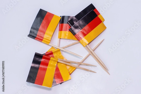 Obraz German national flags lying on white background.