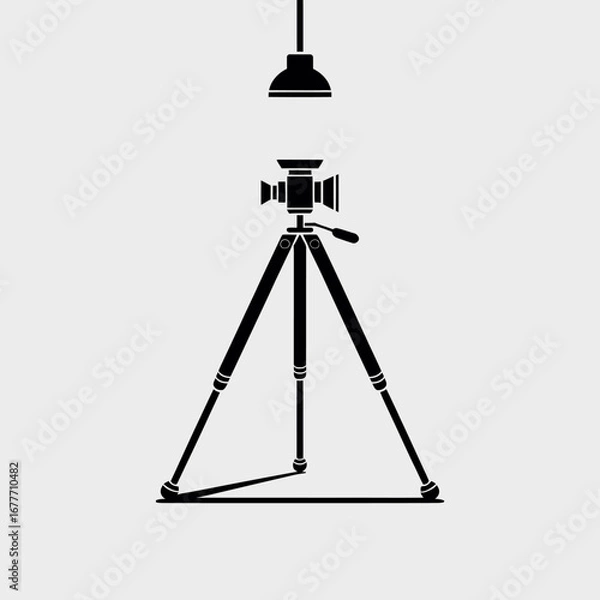 Obraz Vintage camera on tripod illuminated by spotlight in studio