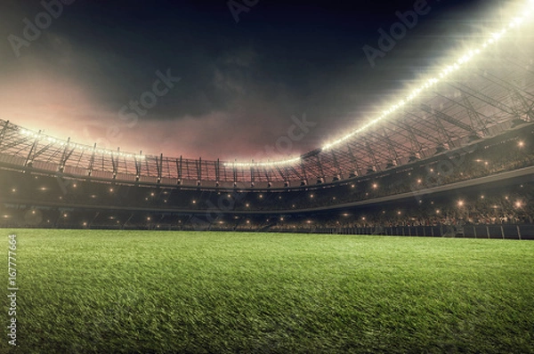 Fototapeta soccer stadium at night with dramatic dark sky