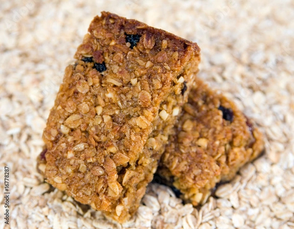 Fototapeta Two flapjacks stacked on an oat background