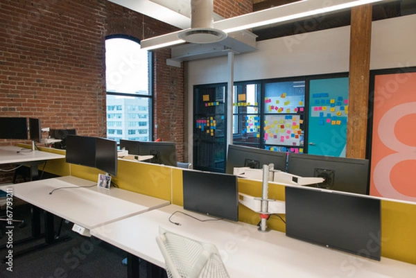 Obraz Trendy modern open concept loft office space with big windows, natural light and a layout to encourage collaboration, creativity and innovation