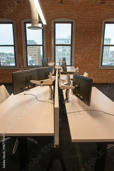 Obraz Trendy modern open concept loft office space with big windows, natural light and a layout to encourage collaboration, creativity and innovation