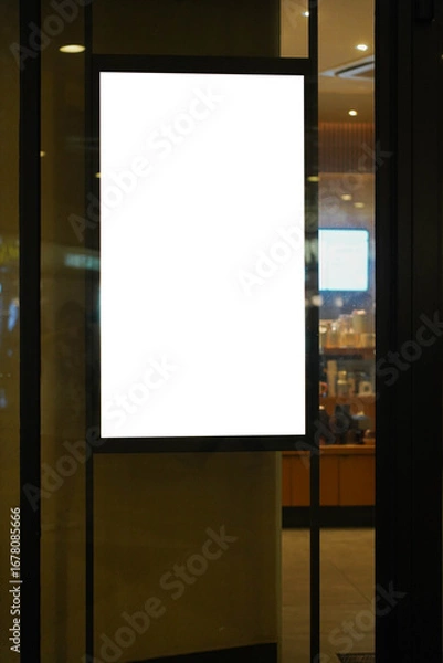 Fototapeta Clear street signage board placed by an outdoor dinning area of a restaurant at night