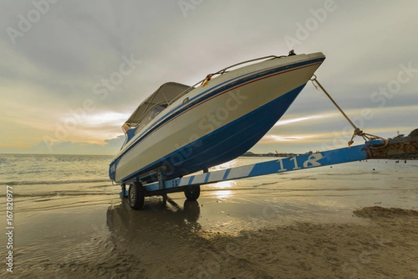 Fototapeta speed boat park on the boat trailers at beautiful sunset environment
