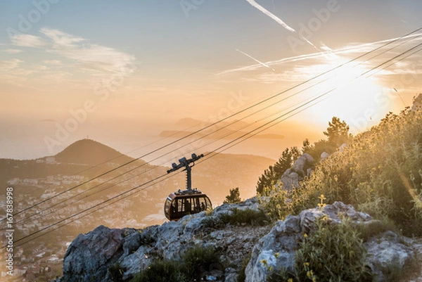 Obraz Cable car moving to the summit of Mount Srd for tourists to enjoy the view of Dubrovnik, Croatia during sunset