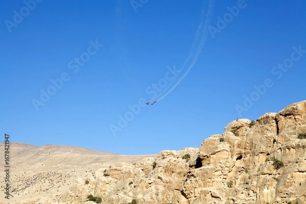 Fototapeta Acrobatic demonstration team of the Royal Jordanian Air Force, the Royal Jordanian Falcons, are flying over LIttle Petra, Jordan