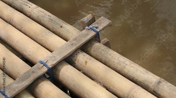 Fototapeta a bridge for crossing made of bamboo trees, woven and nailed in a row
