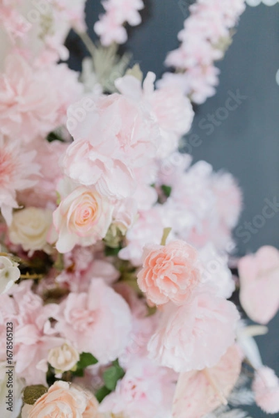Fototapeta A beautiful close-up of delicate pastel pink flowers, including roses and peonies, captured in soft natural light.