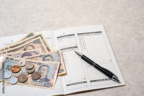 Fototapeta 家計簿、豊かで楽しい家庭生活を送るために必要な支出と収入を管理する