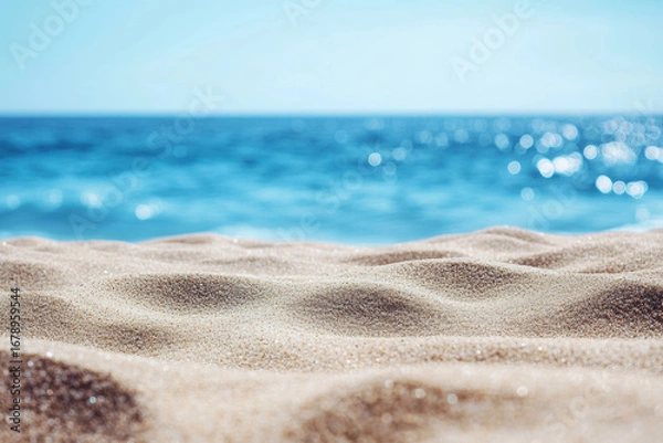 Fototapeta Soft sandy beach with ocean waves gently lapping in the background