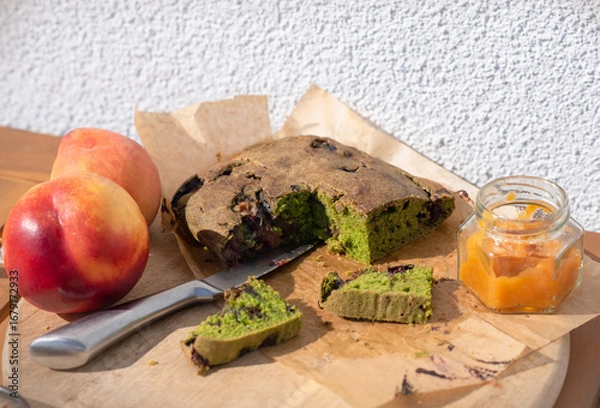 Fototapeta Gluten free homemade spinach cake with plums, served with homemade apricot jam on wooden board