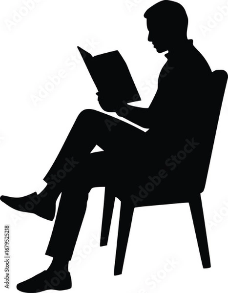 Obraz Silhouette of a man reading a book while sitting on a chair