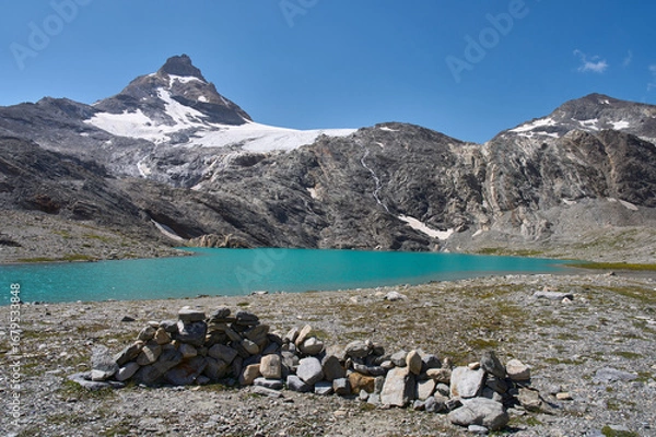 Fototapeta Small lake Goletta beneath the peak of Granta Parey in the Graian Alps in Italy. A glacial lake of turquoise color, fed by the melting waters of Goletta glacier. Hiking trail from refuge Benevolo.