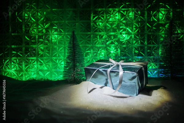 Fototapeta Christmas home decoration with snow and tree on a dark background with copy space. Selective focus. New Year attributes on background