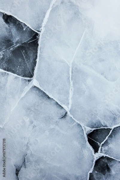 Fototapeta Cracked ice surface with frosty fractures