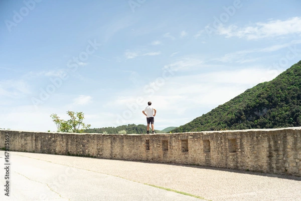 Fototapeta man walking on the road