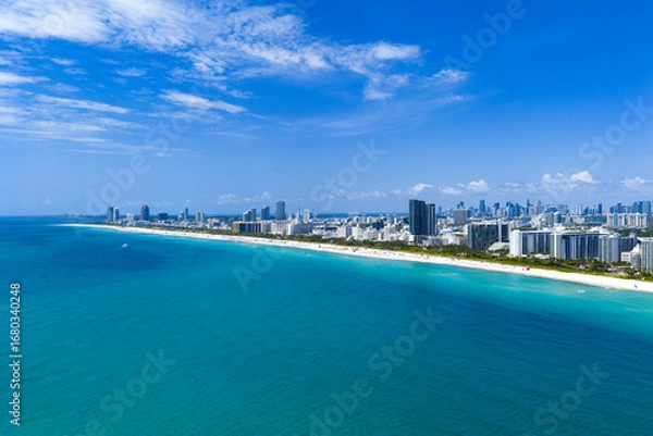 Fototapeta Miami beach with turquoise waters. Aerial view of sandy coastline and waves. Tropical Miami Beach scene with sandy beach. Oceanfront of South Miami. Panoramic of Miami Beach.