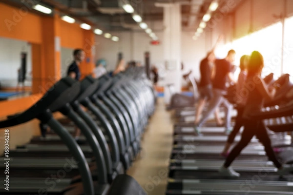 Fototapeta Row of treadmills in modern fitness center.