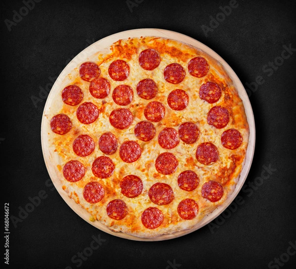 Obraz Pepperoni pizza on a black background. Visit my page. You will be able to find an image for every pizza sold in your cafe or restaurant 