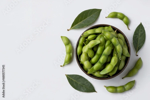 Fototapeta Top down view of fresh green edamame pods in a bowl with leaves soybeans