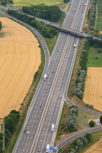 Fototapeta Autobahn mit Ausfahrt Straße Verkehr Transport Hochformat Luftbild Luftaufnahme