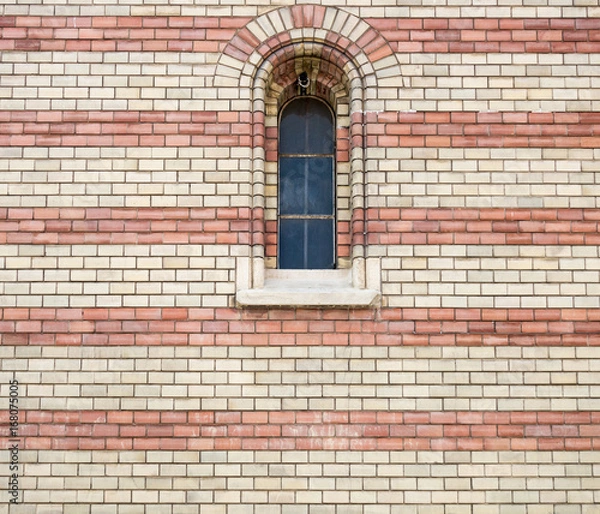 Fototapeta Metallic window and background of two colors brick wall, with fine texture