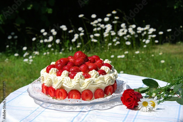 Obraz Garden table with a strawberry cake and summer flowers