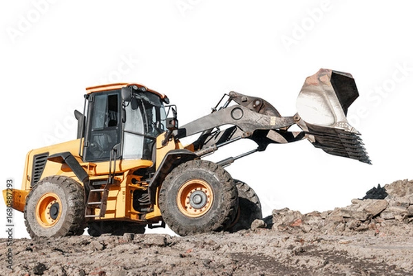 Fototapeta A heavy wheel loader or bulldozer is actively digging and moving dirt at a construction site, showing off its powerful front loader capabilities against an isolated background.