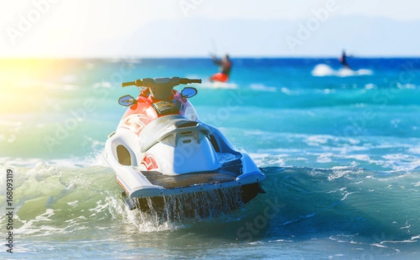 Obraz modern jet sways in the surf near shore on background of mountains in Greece