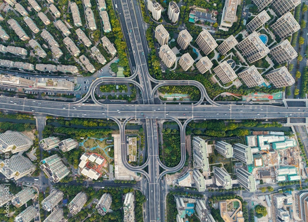 Fototapeta Aerial top down view of a busy junction reveals a multitude of vehicles traveling on various roadways. Hangzhou, China.