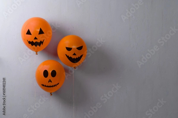 Fototapeta Orange balloons for Halloween party on gray background. Space for text