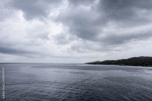 Obraz Ocean horizon small piece of land dramatic grayish cloudscape background image