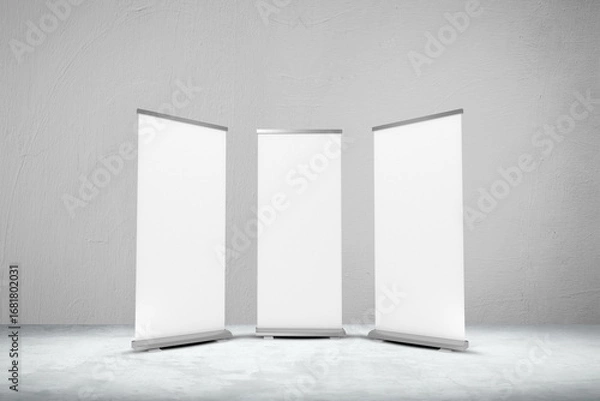Fototapeta Empty three rollup banners stand. Blank template mockups. Exhibition stand 3 roll-up banners, screen for you design. Vertical white roll up for preview.