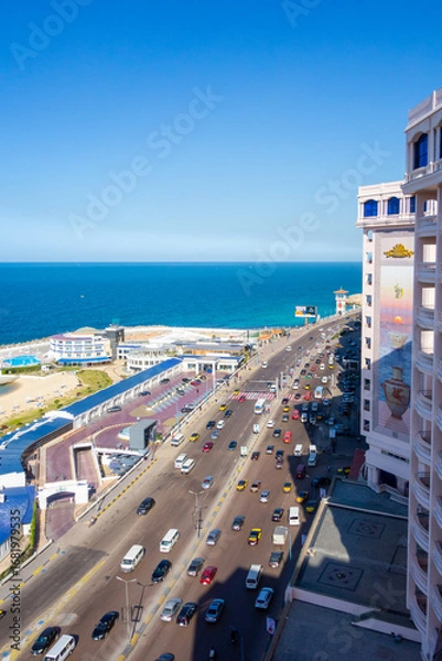 Fototapeta An elevated view capturing the bustling traffic and modern buildings along the coastline of Alexandria