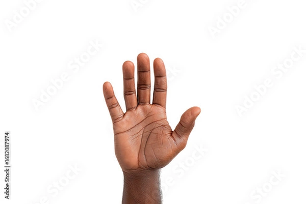 Fototapeta Dark-skinned hand raised in a stop or rejection gesture against a black background. Palm facing forward, fingers extended outwards