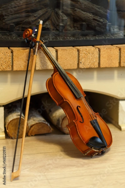 Obraz old violin by the fireplace