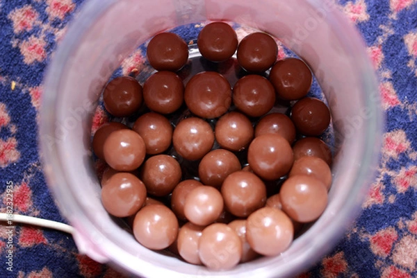 Fototapeta chocolate ball biscuits in a container