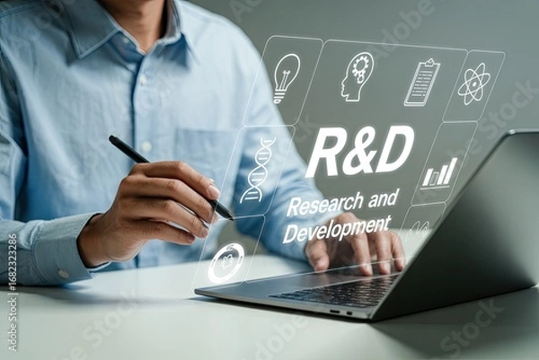 Fototapeta Person pointing at r&d text and icons on a laptop screen representing innovation and research