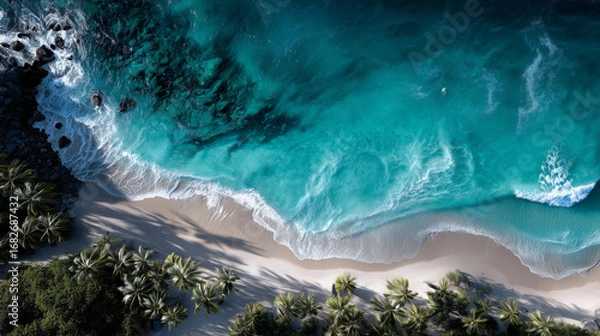 Fototapeta Stunning aerial view of tropical beach with turquoise waters and lush palm trees in bright sunlight