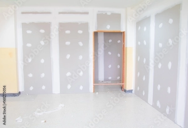 Fototapeta gypsum board wall interior decoration of home at construction site with copy space add text