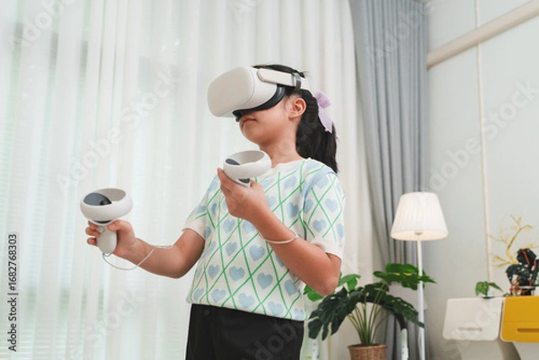 Fototapeta Child learning through interactive gaming and simulation. VR for edutainment.