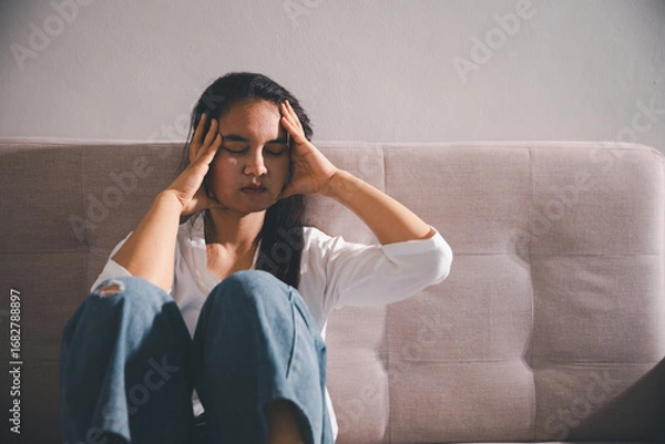 Fototapeta Despair sorrow person in empty dark room, Depressed young woman covering face with hands. Young woman coping with distress covering face. mental health concept. Boring sad upset frustrated stressed.