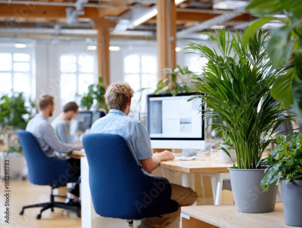 Obraz Programmers working in modern green office with plants