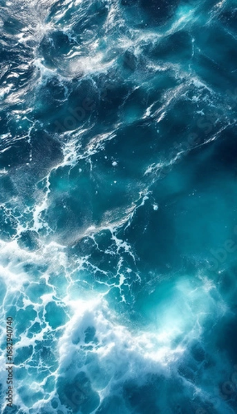 Fototapeta Top-down close-up of the open ocean with deep blue waves and foam
