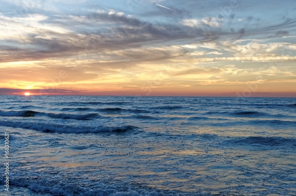 Fototapeta Sunset over sea. Colorful sky and waves at sea. Poland, Jastrzebia Gora
