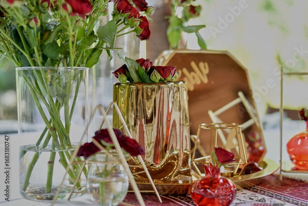 Obraz Red decorative vase in the shape of a pomegranate. Wedding table d cor. Gold and white