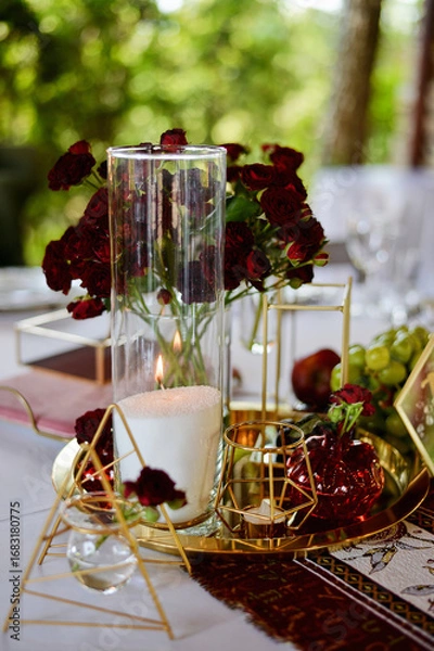 Obraz Red decorative vase in the shape of a pomegranate. Wedding table d cor. Gold and white