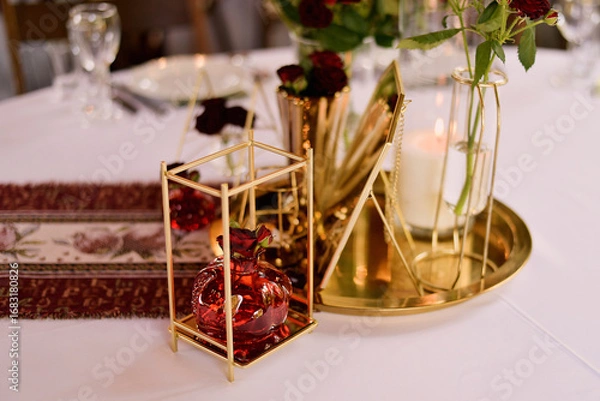 Obraz Red decorative vase in the shape of a pomegranate. Wedding table d cor. Gold and white