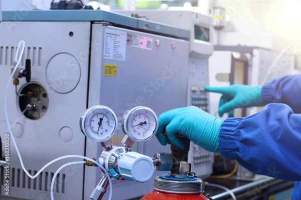Obraz hand work and start Gas Chromatography Analyzer in laboratory