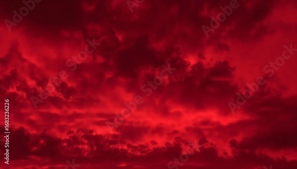 Fototapeta Dramatic red sky with ominous clouds creating a powerful and intense atmospheric phenomenon